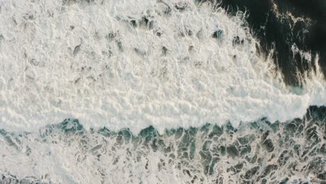 aerial view of foamy white waves crashing on the monterrico beach in santa rosa, guatemala