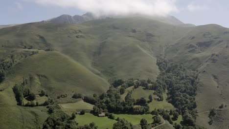 hazy aerial rises over vivid green french pyrenees mountain landscape
