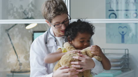 doctor and child with teddy bear