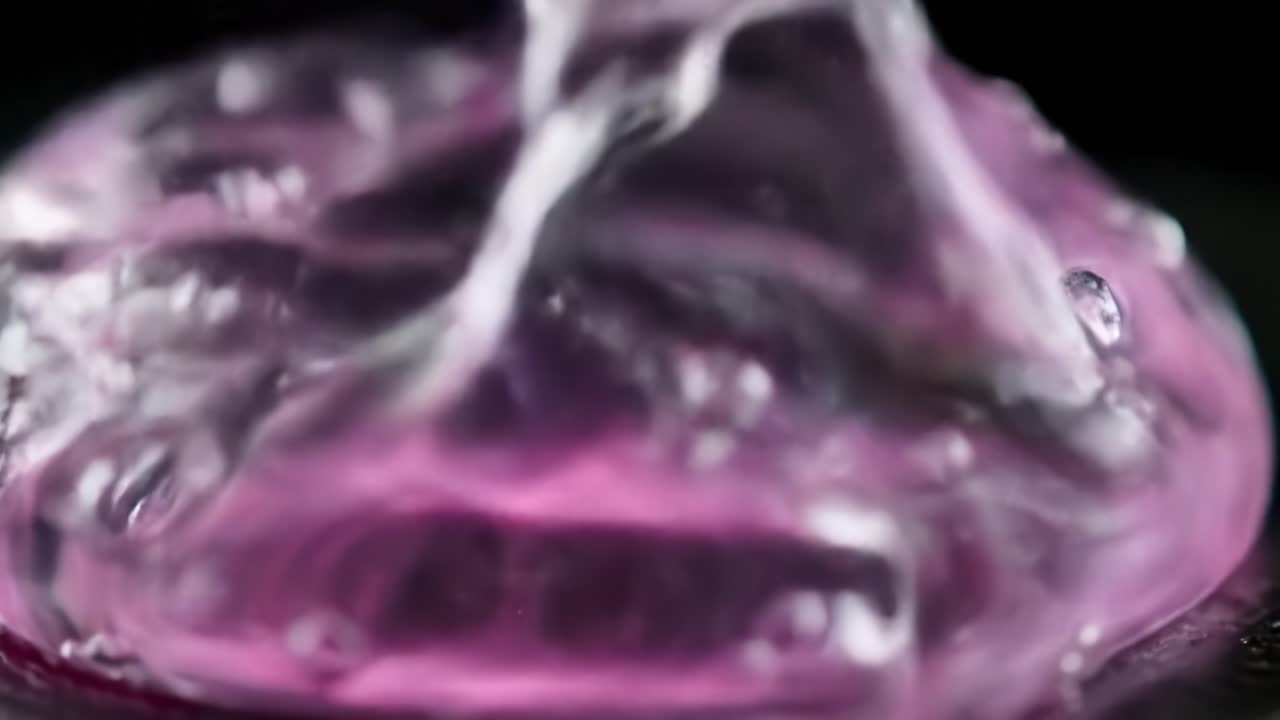 Captivating Close-Up of Water Droplets on a Vibrant Surface: Exploring the Beauty of Fluid Dynamics and Color Interplay