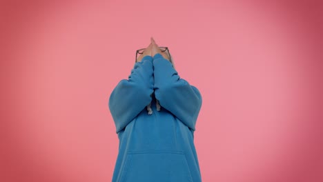 woman with gray hair and blue hoodie looking down with arms crossed