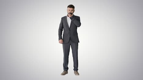 businessman using speak activate virtual digital voice assistant on smartphone on gradient background