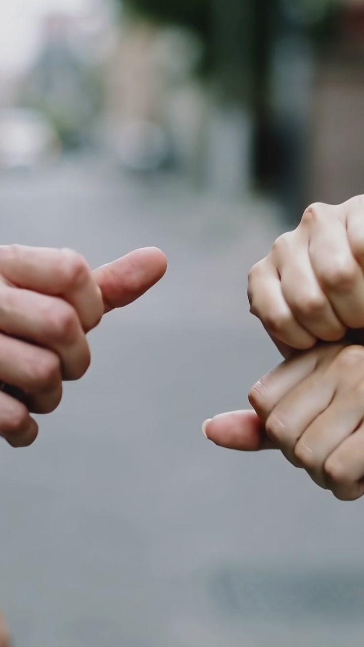 Vertical video: Placing palms together, pair sliding, tapping hands on street, greeting final fists