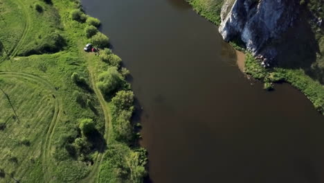 aerial view of river with people camping