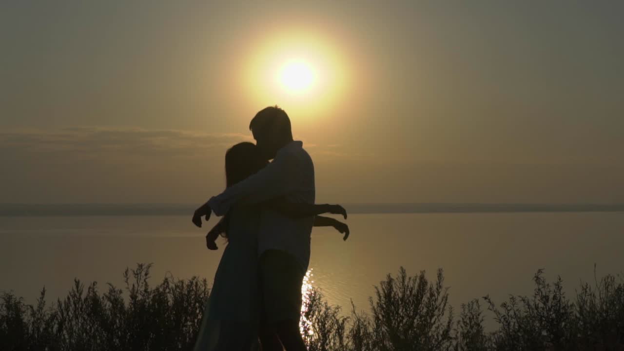Couple Embracing at Sunrise over a Lake