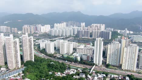 aerial view of hong kong sha tin mega residential buildings with lion rock mountains in the background