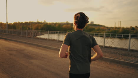 sporty man is jogging in sunny morning or evening workout and fitness for good health