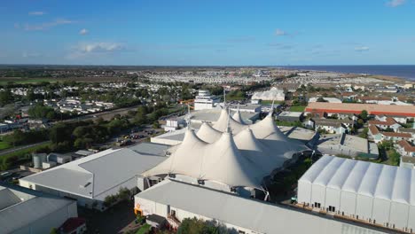 Aerial-drone-footage-of-the-famous-Butllins-holiday-camp-based-in-the-seaside-town-of-Skegness-Lancashire,-UK