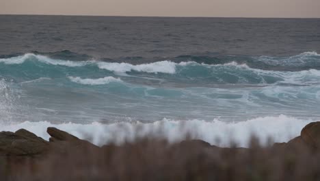 rocky ocean coast, dramatic sea waves, monterey beach, california, birds flying.