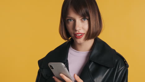happy young woman smiling and using smartphone