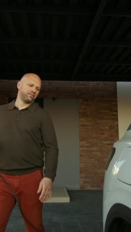 man charging an electric vehicle