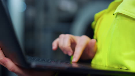 Closeup-hands-typing-laptop-computer-on-modern-facility.-Project-work-concept