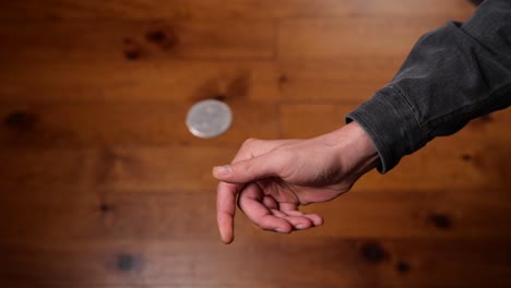 hand tossing coin to flip on heads or tails and catch it on the fly