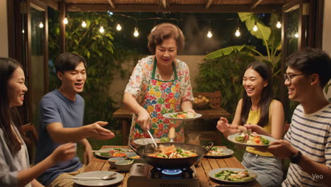 happy asian family dinner in the garden