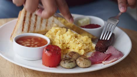 person eating an english breakfast