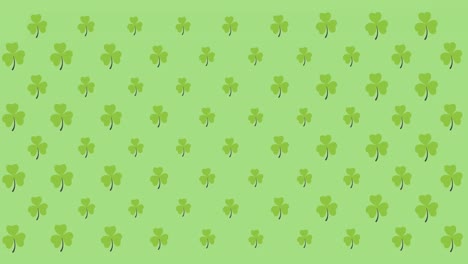 digital animation of multiple clover leaves moving against green background