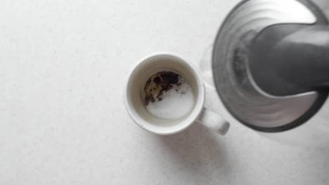 the process of brewing instant coffee in the morning on a white table, top view.