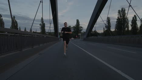 an athlete goes running, jogging on a bridge on the main in frankfurt