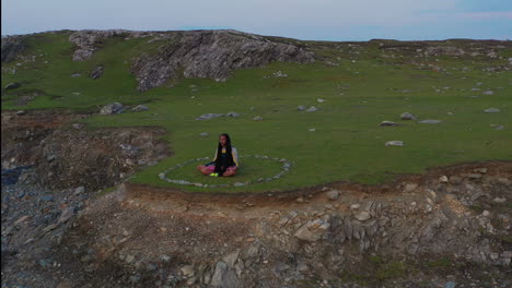 man meditating in beautiful coastal scenery