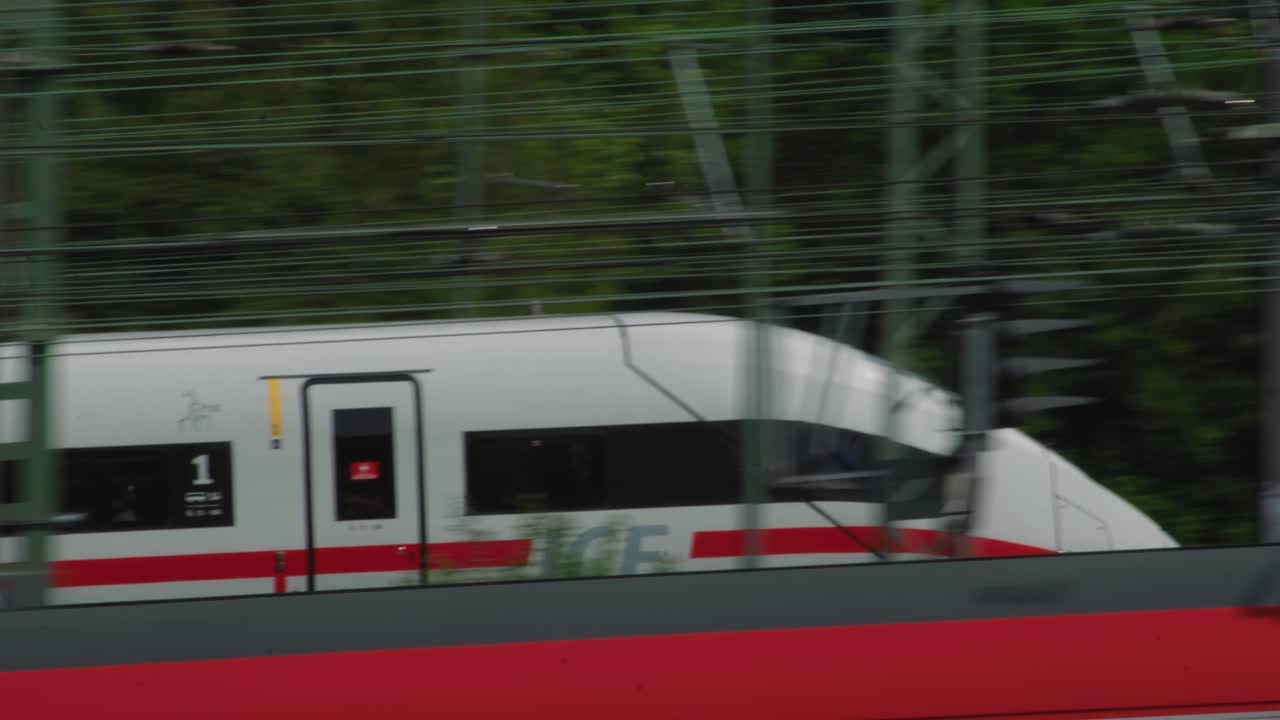 German ICE passenger train passing by tracked by camera closeup