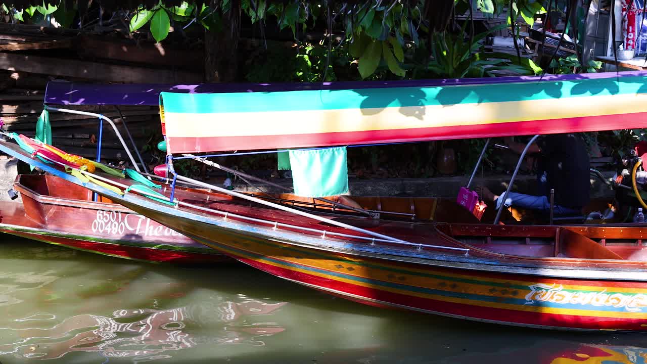un colorido barco de cola larga en un canal tailandés