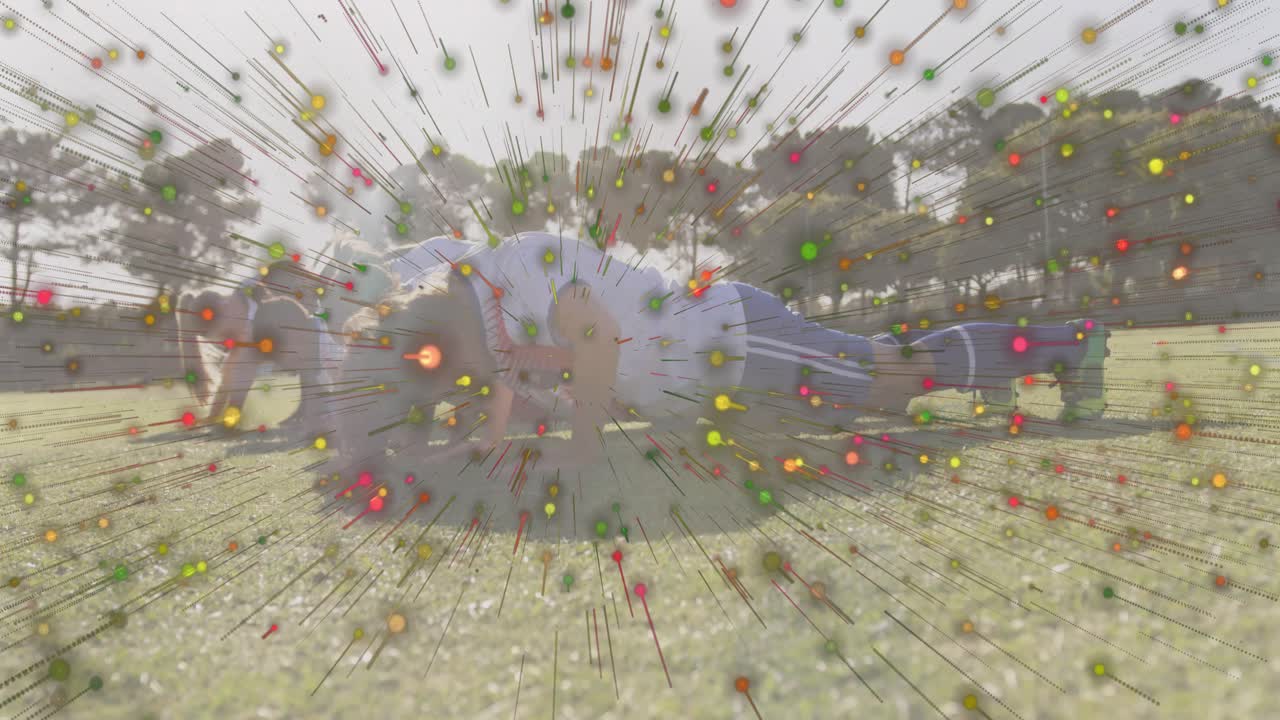 Mid adult female entering plank in park initiating dots bursting as fitness class mirroring pushups