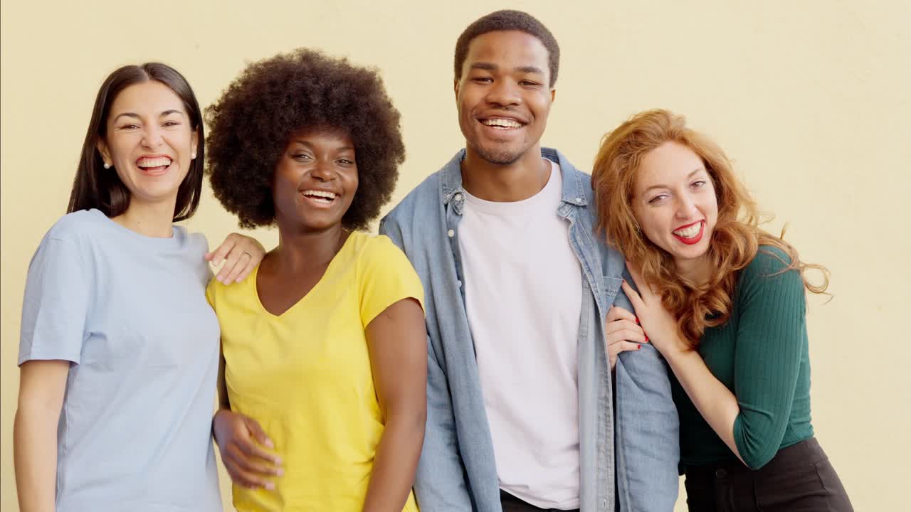 Joyful group of diverse friends laughing and dancing