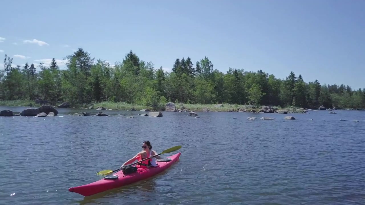 Mother and toddler kayaking in rocky Colorado lake, Tracking Aerial