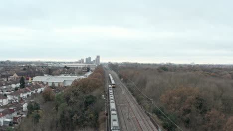 Dolly-back-drone-shot-of-Great-western-railway-high-speed-train-and-Heathrow-express