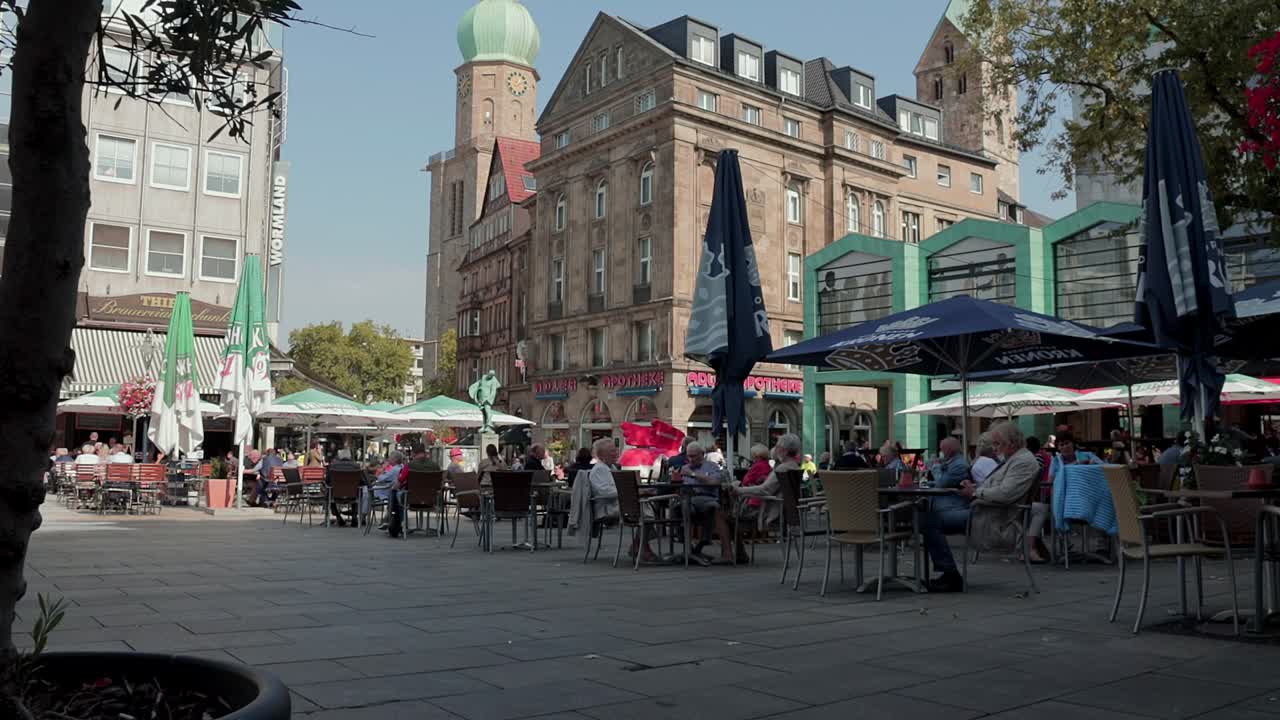 Normal life at old market square Dortmund Germany tilt up