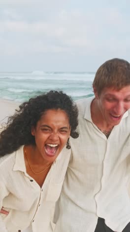couple enjoys a joyful moment on the beach during sunset stroll