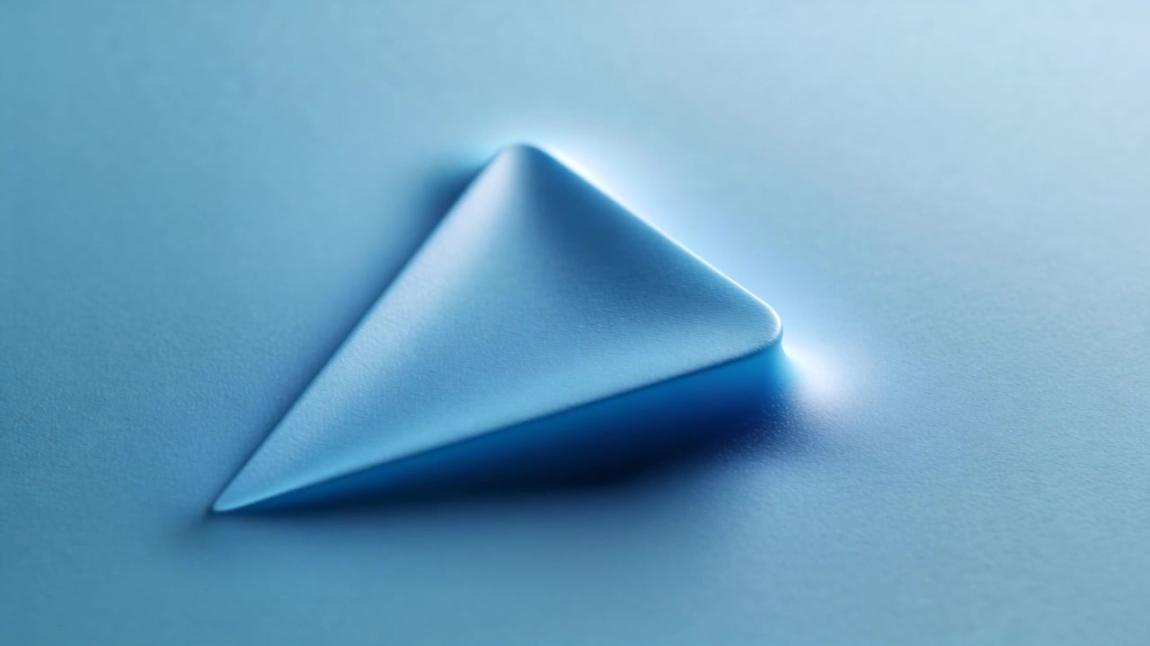 Rising triangle mound pushing blue membrane from tension in studio, showing bright rim