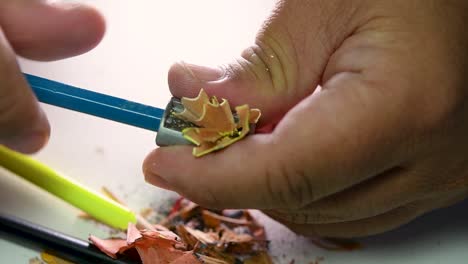 Footage-of-hands-slowly-sharpening-a-pencil-and-some-coloured-pencils-with-a-Wedge-Pencil-Sharpener