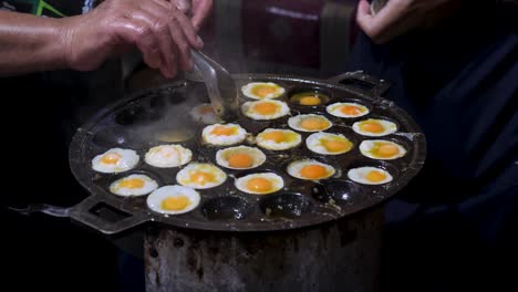 cooking multiple quail eggs in a hot pan