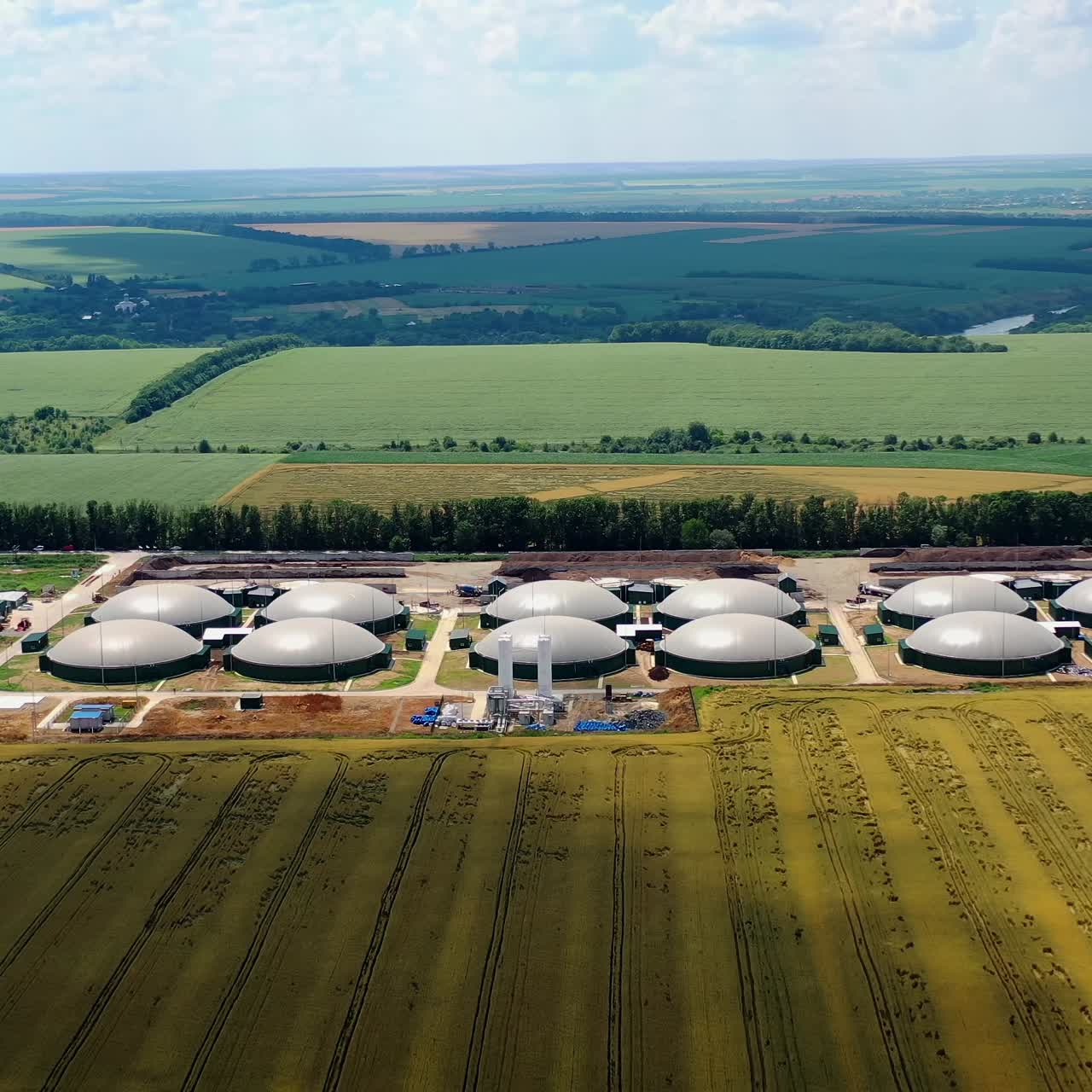 Large gas storage on the field. Factory and power plant with many storage tanks