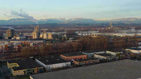 Aerial-descending-into-an-industrial-park-at-sunset