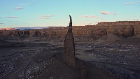 sharp rock formations in mountainous valley under sunset sky