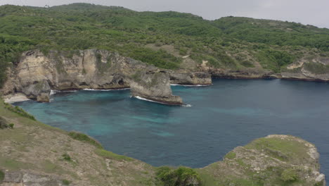 steep rocky coast with cliffs at nusa penida, bali, indonesia. aerial shot