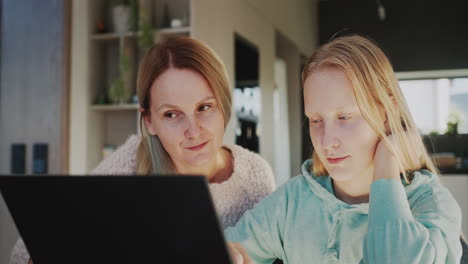 Mom-and-daughter-use-laptop-together.-Homeschooling-concept