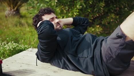 Man Struggles to Do Sit Ups During Outdoor Workout