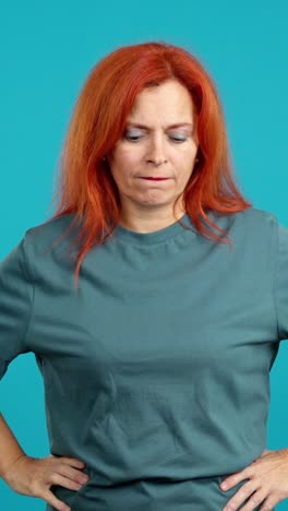 woman with red hair expressing various emotions on blue background