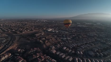 a drone shot of a hot air balloon in albuquerque, new mexico