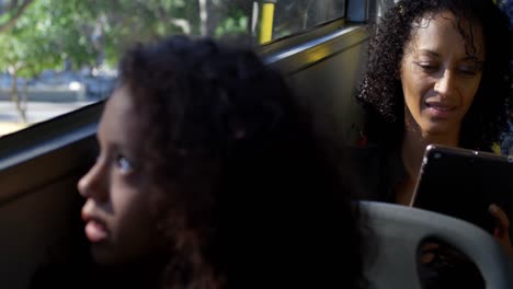 female commuter using digital tablet while travelling in bus 4k