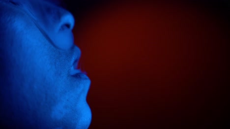 slow motion macro of rising smoke of cigarette inside party nightclub - woman lighting in blue color