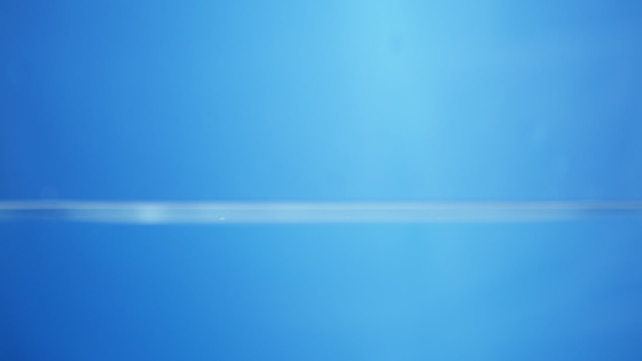 Smooth close-up view of the water surface in motion, showcasing the clarity and purity that signify high-quality drinking water.