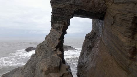 aerial fly through of ocean cave