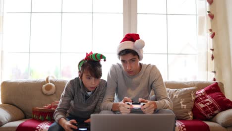 two brothers playing computer games at christmas time