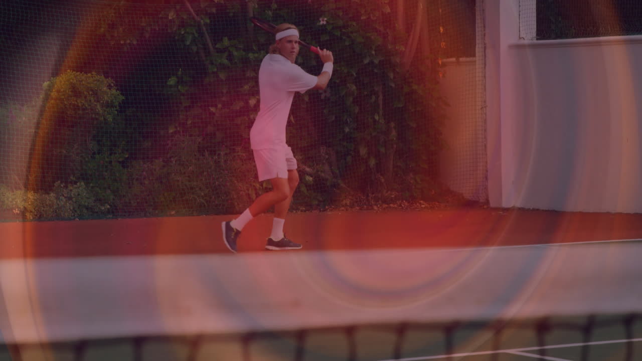 Male tennis player swinging racket on court, showing animated sports analytics line and lens flares