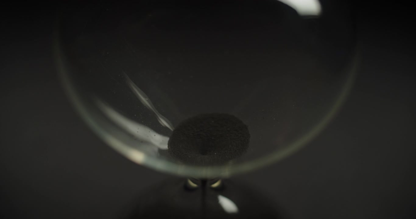 Macro shot of black sand stops pouring
