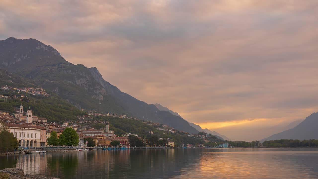 Timelapse of Lake Iseo at sunrise, on the left the city of lovere which runs along the lake,Bergamo Italy.